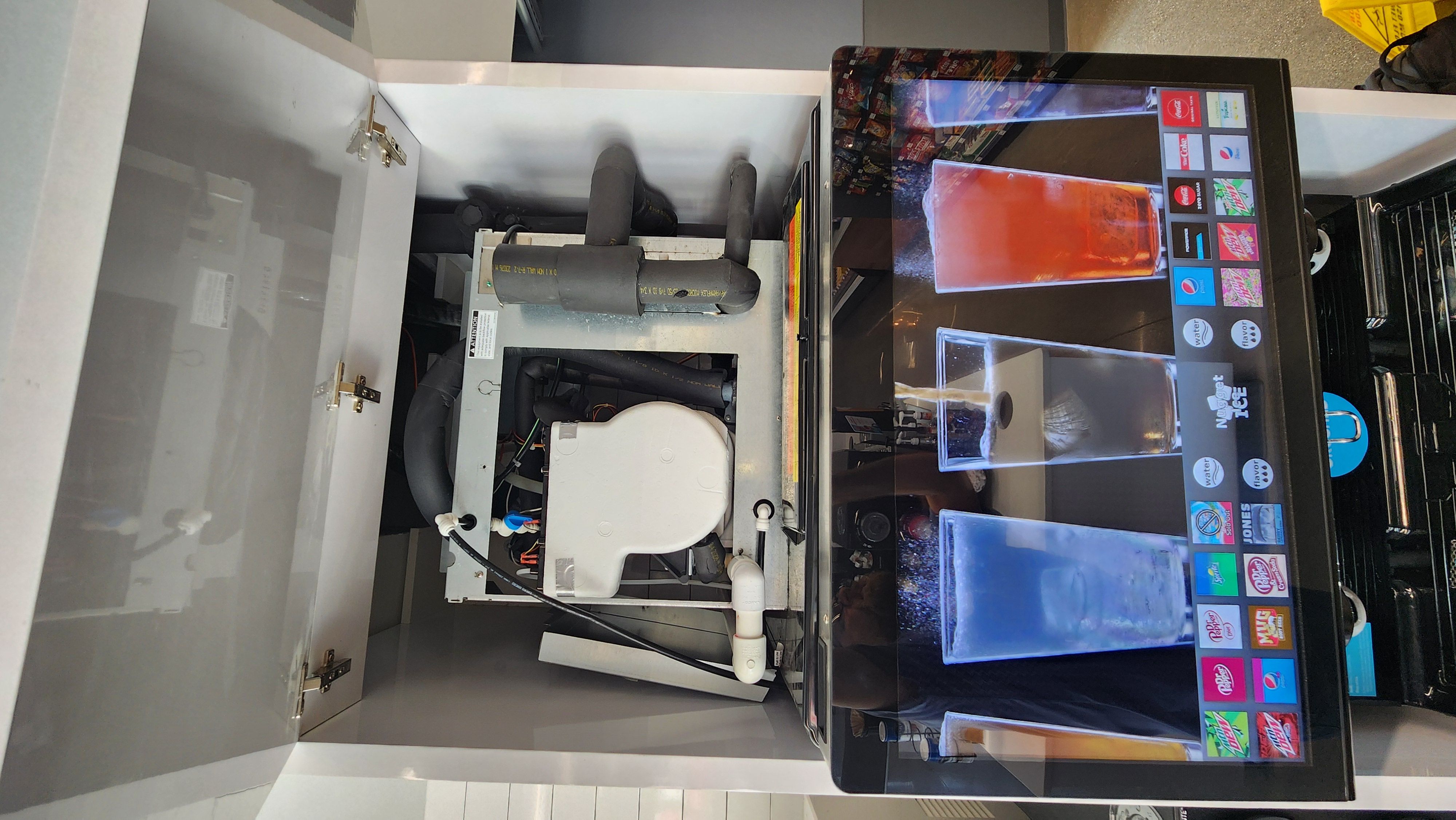 Inside view of a soda fountain machine with drink selection screen
